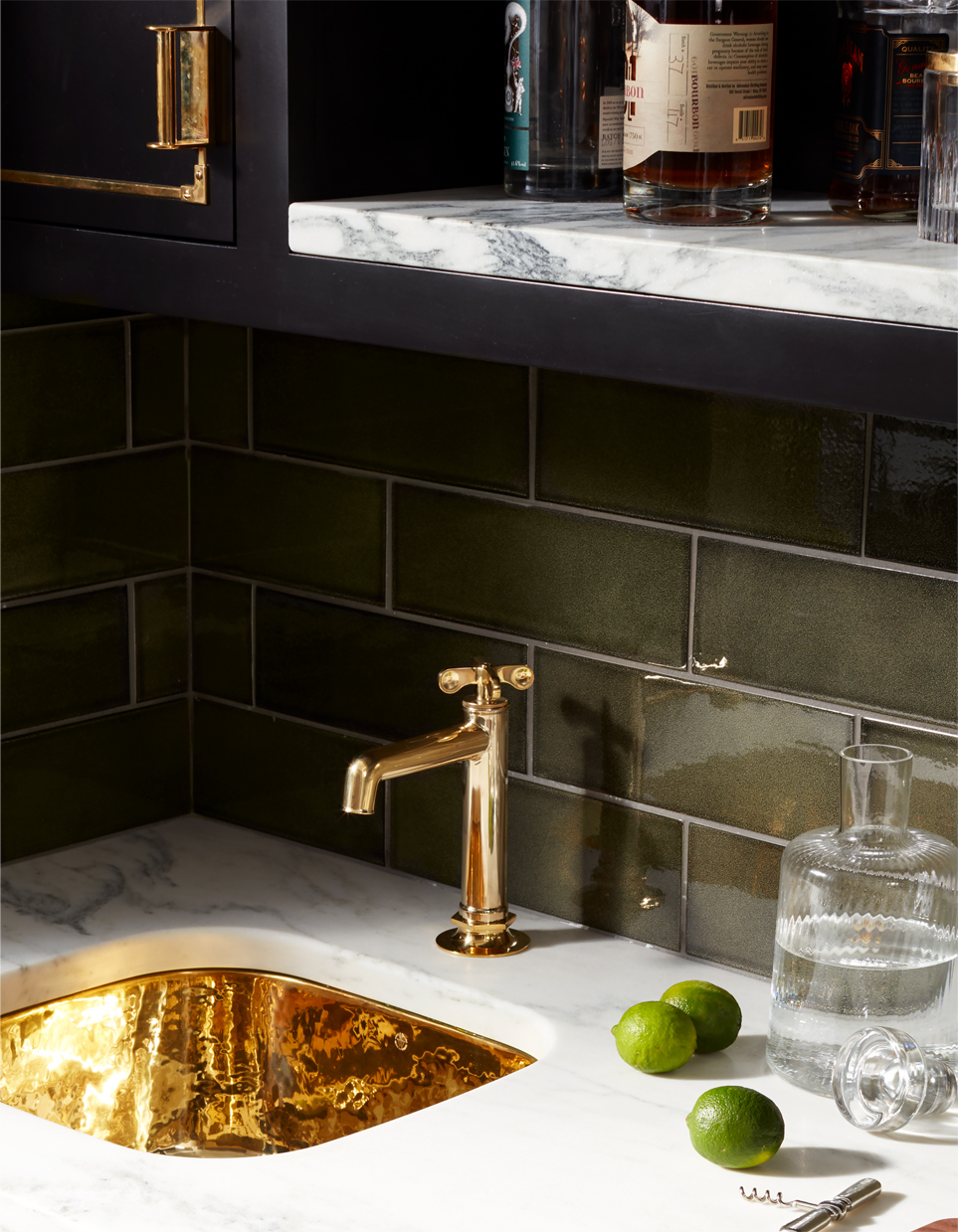 PULLMAN CABINETRY IN RAVEN WITH UNLACQUEREED BRASS HARDWARE, HENRY FAUCET IN UNLACQUERED BRASS, NORMANDY COPPER BAR SINK IN UNLACQUERED BRASS AND ARCHITECTONICS BACKSPLAHS IN SHAGREEN